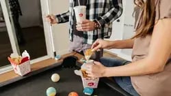 Friends playing pool while eating Jack in the Box Tiny Tacos-1