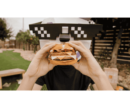 Jack Box eating a Jumbo Jack Burger