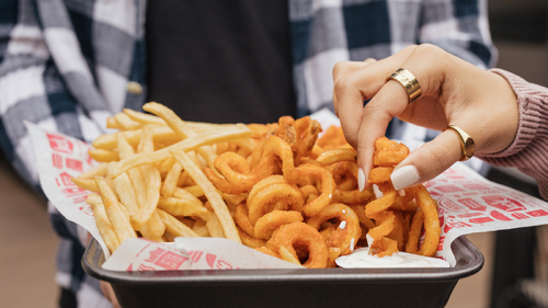 Tray of Jack in the Box Curly Fries and French Fries.