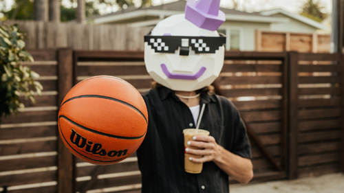 Jack Box holding basketball and drinking a Jack in the Box coffee