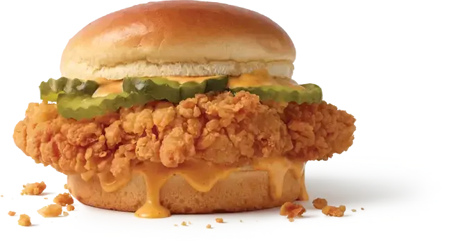 A Jack in the Box Cluck Chicken Sandwich with pickles and sauce.
