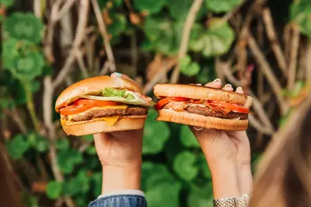 Two hands holding up a Sourdough Jack with a Jumbo Jack with Cheese 5000 WEb P-1